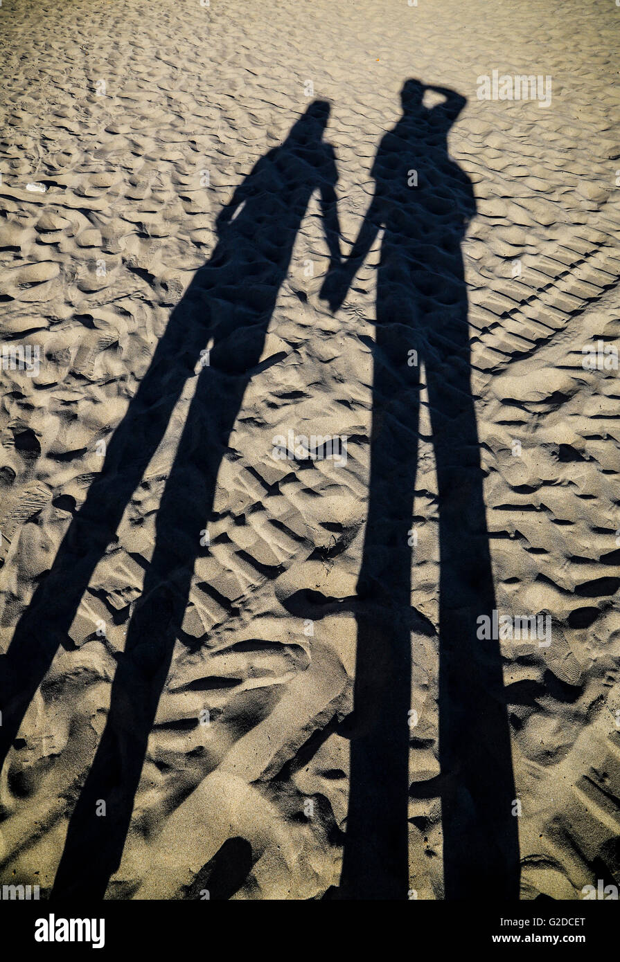 Shadow of Couple Holding Hands on Beach Stock Photo Alamy