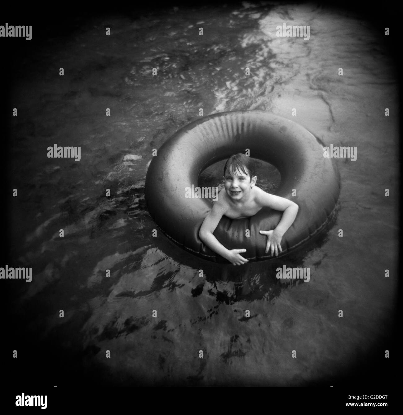 Smiling Boy in Inner Tube Stock Photo Alamy