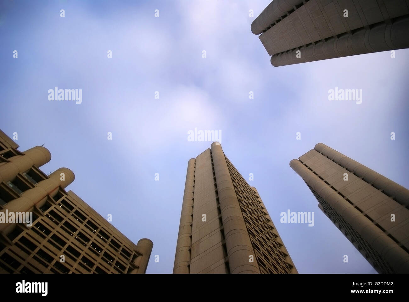 Four modern concrete high-rises pointing at sky at sunset Stock Photo ...