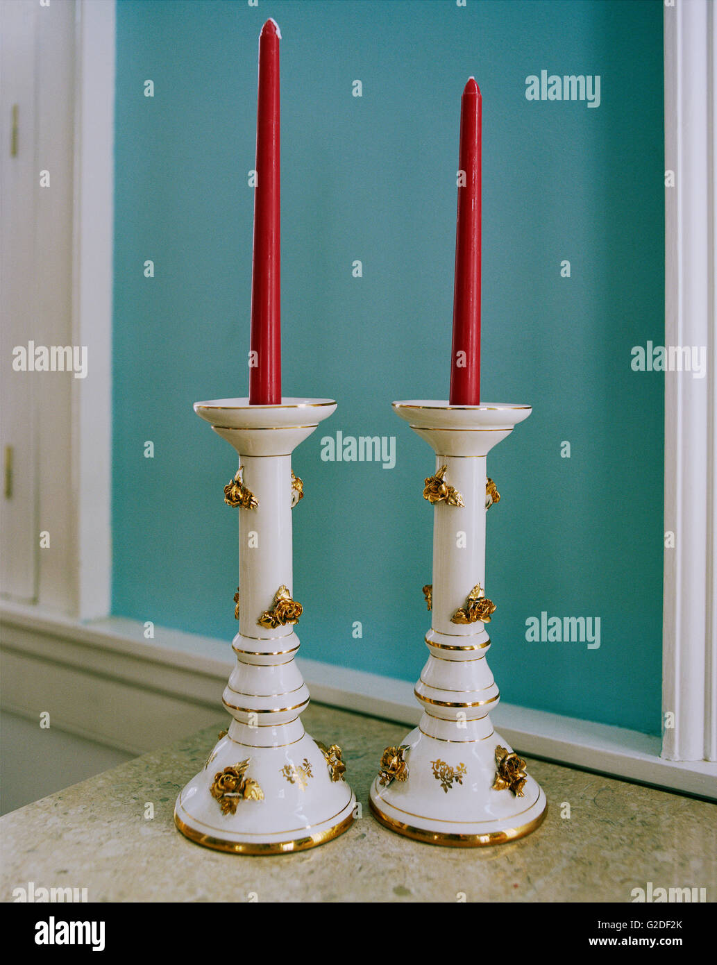 Two Candlesticks with Red Tapered Candles Stock Photo Alamy