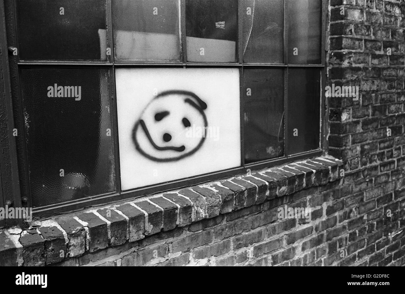 Smiley Face Painted on Urban Window Stock Photo