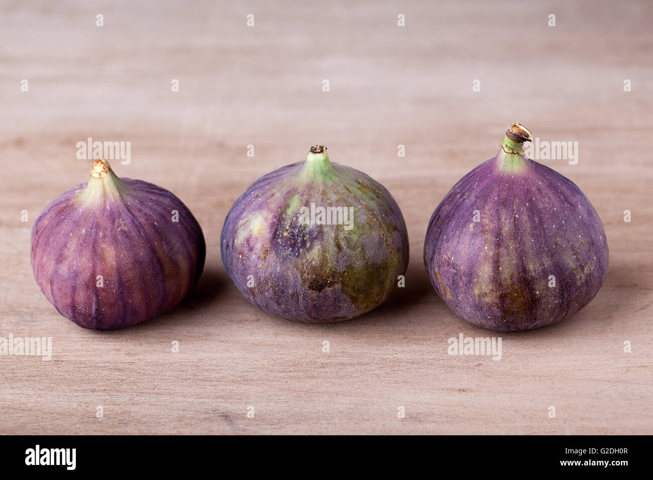 Fresh fig fruits arranged on wooden table Stock Photo