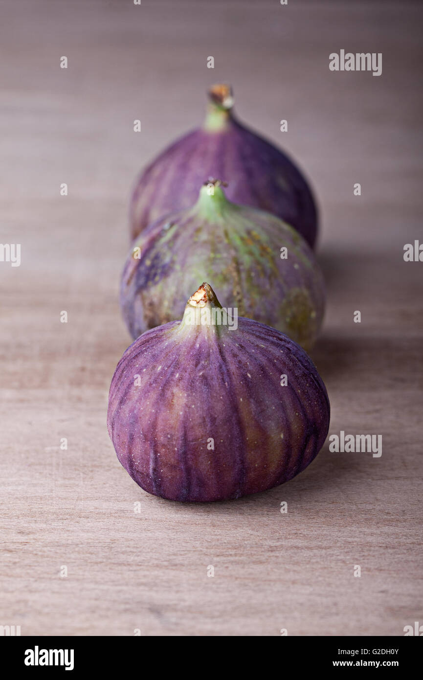 Fresh fig fruits arranged on wooden table Stock Photo