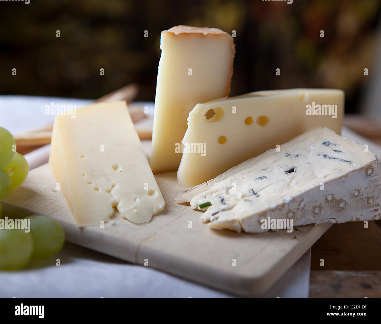 Three kinds of french cheese and white grapes Stock Photo