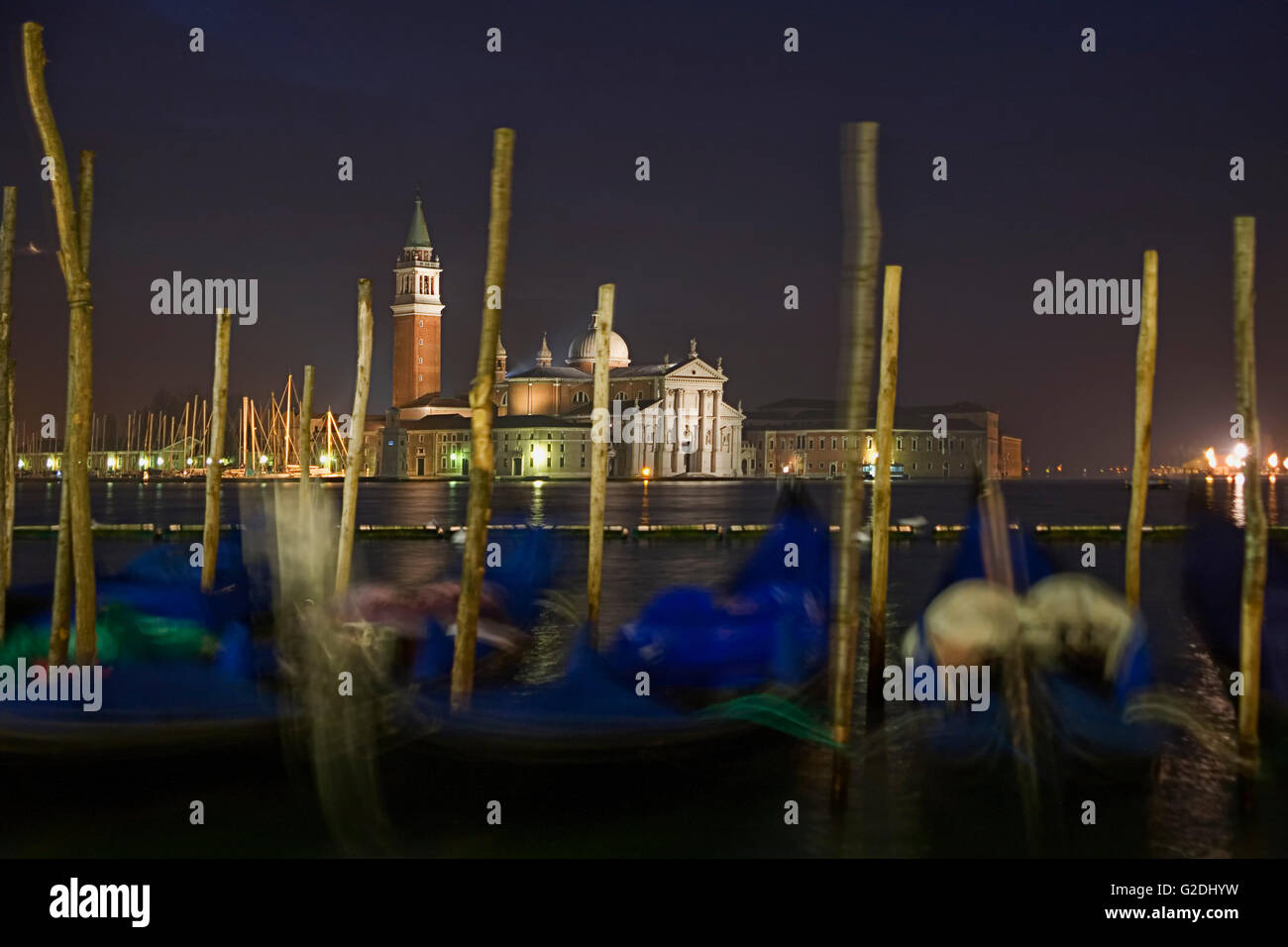 Chiesa di San Giorgio Maggiore, Venice, Italy, across the basin of St Mark at dawn: a line of moored gondolas in the foreground Stock Photo