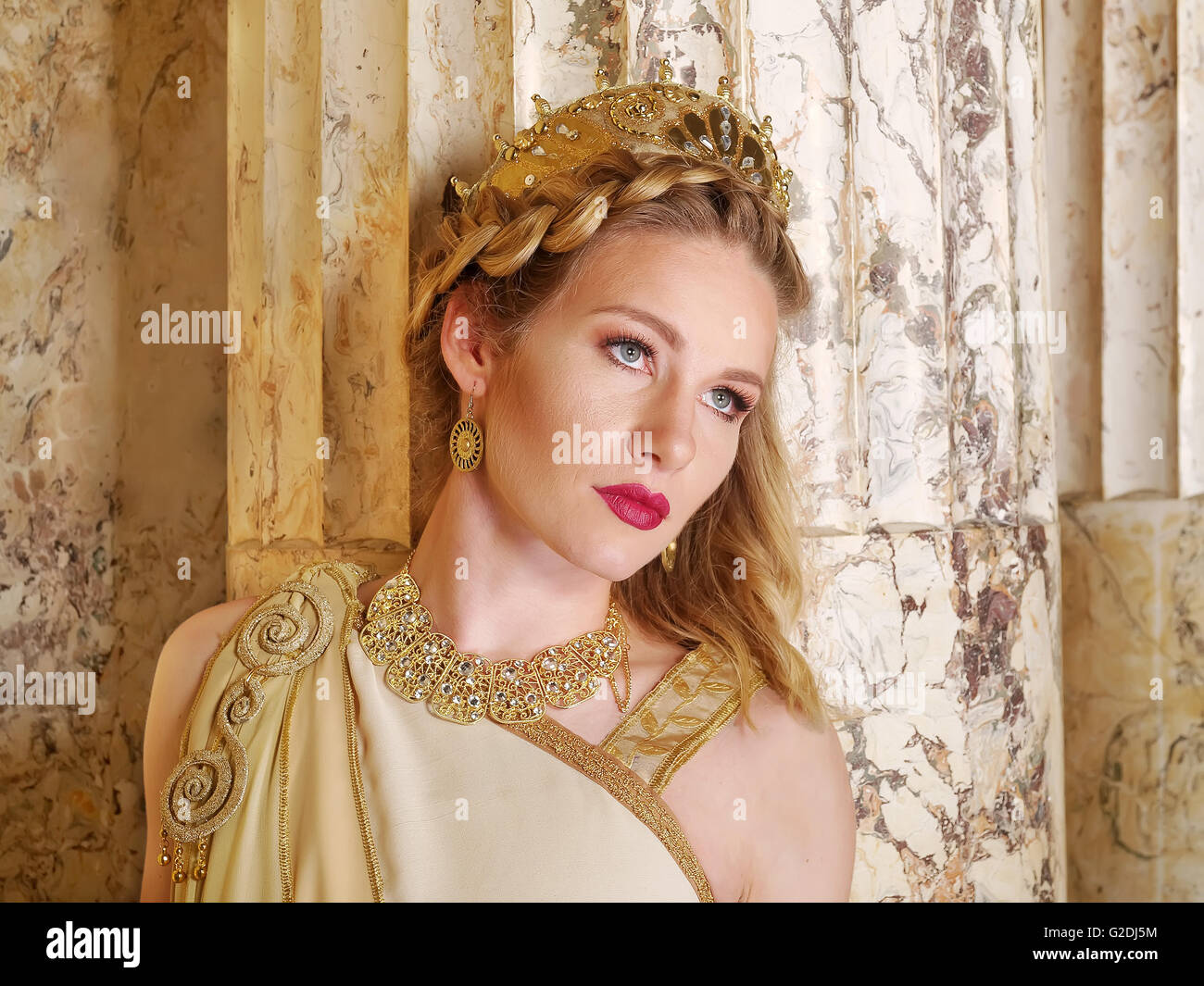 woman in traditional roman clothing posing in temple Stock Photo