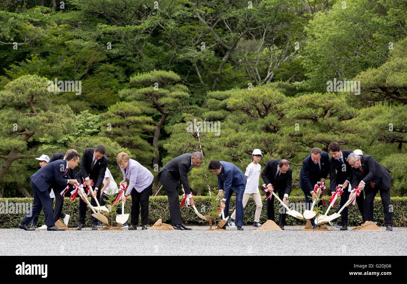 World leaders at the G7 Summit meeting plant trees in honor of their visit to the Ise Jingu Shinto shrine May 26, 2016 in Ise, Japan. Left to Right: Governor of Mie Prefecture Eikei Suzuki, Italian Prime Minister Matteo Renzi, German Chancellor Angela Merkel, U.S. President Barack Obama, Japanese Prime Minister Shinzo Abe, French President Francois Hollande and British Prime Minister David Cameron, Canadian Prime Minister Justin Trudeau, and European Commission President Jean-Claude Juncker. Stock Photo