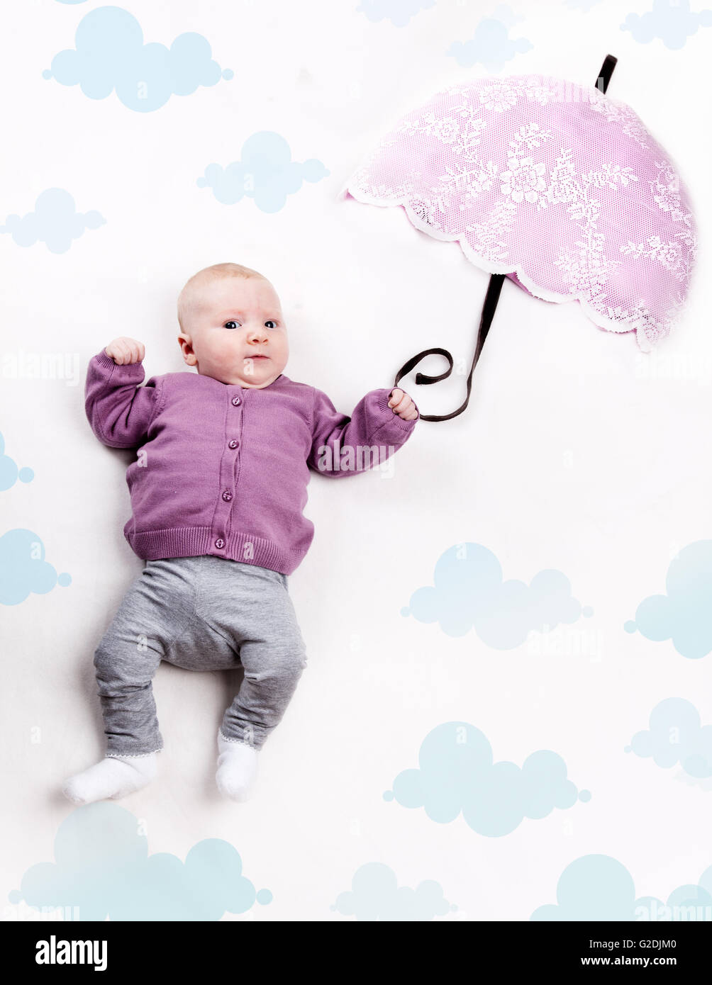 4 Month old Baby girl flying with cloth umbrella Stock Photo