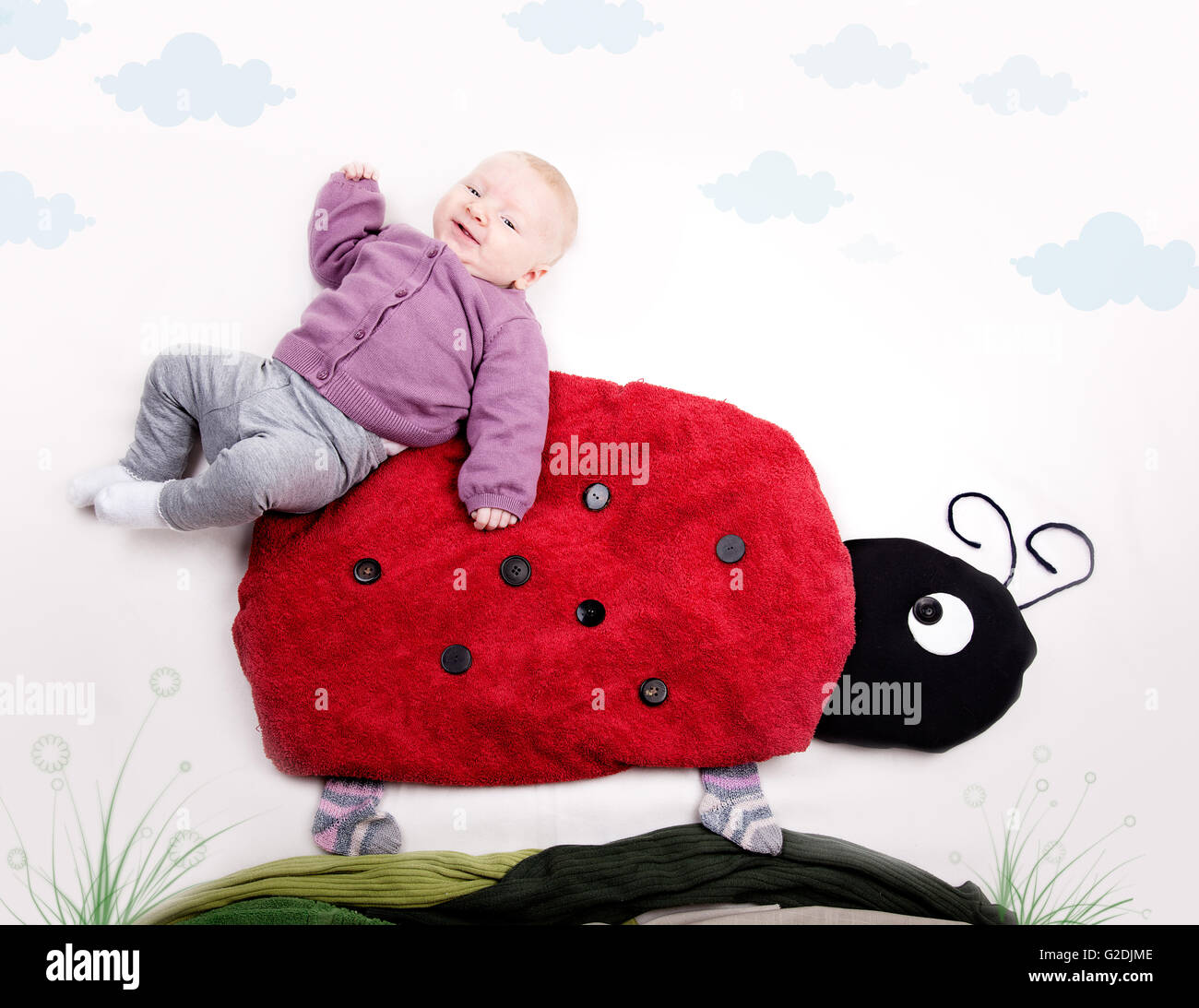 4 Month old Baby girl riding on Ladybug Stock Photo Alamy