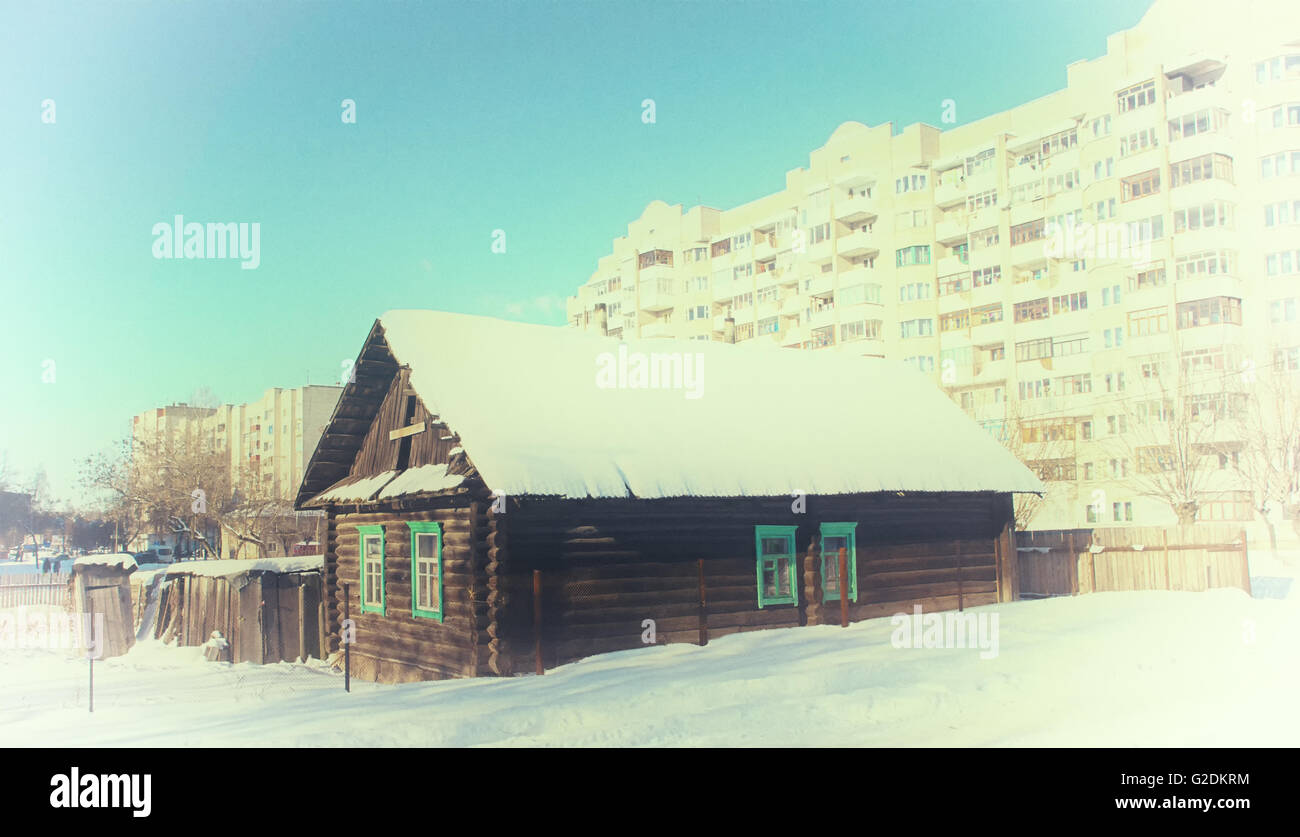 Strange High Rises The wooden house is strange is situated among the high-rise houses. Old ...