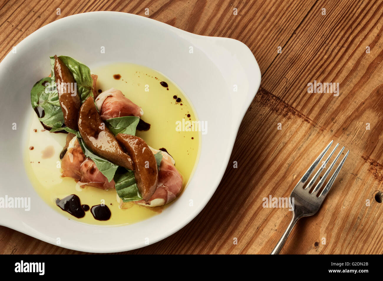 Mozzarella and Prosciutto on Plate with Balsamic Vinegar and Oil Stock Photo