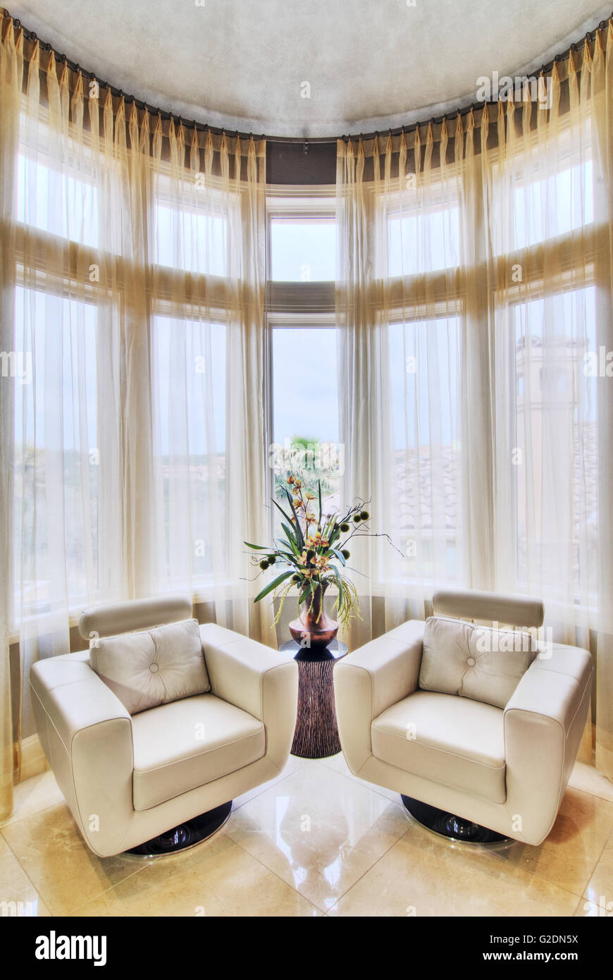 Two Leather Swivel Chairs in Front of Curved Window Stock Photo Alamy