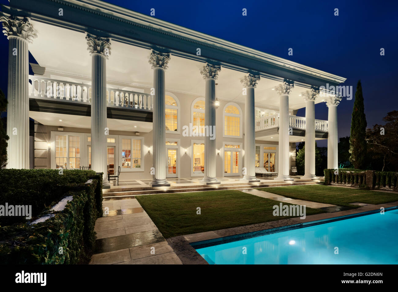 Mansion with Columns and Swimming Pool at Night Stock Photo