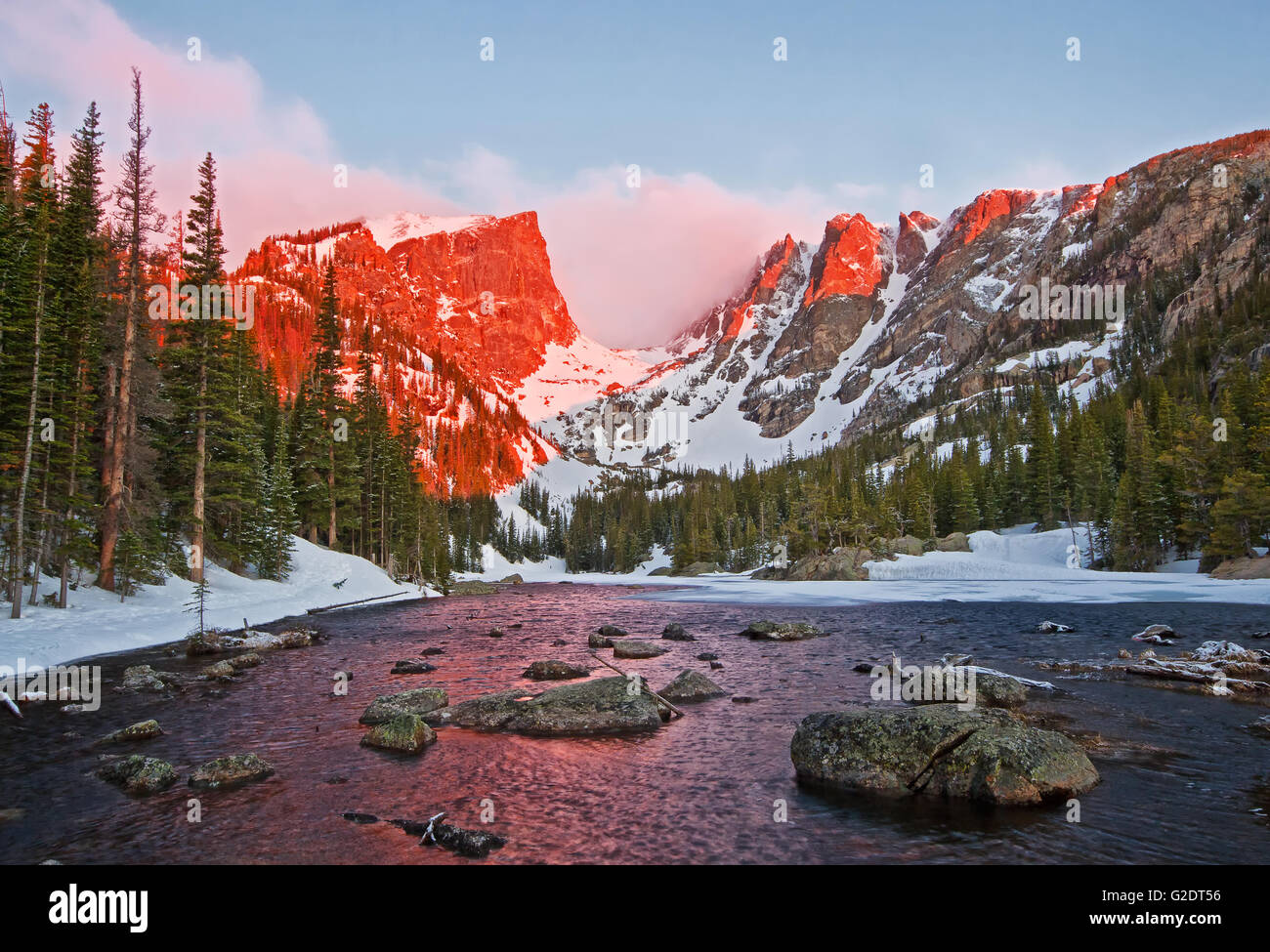 The peaks glow at sunrise at Dream Lake in Rocky Mountain National Park Stock Photo