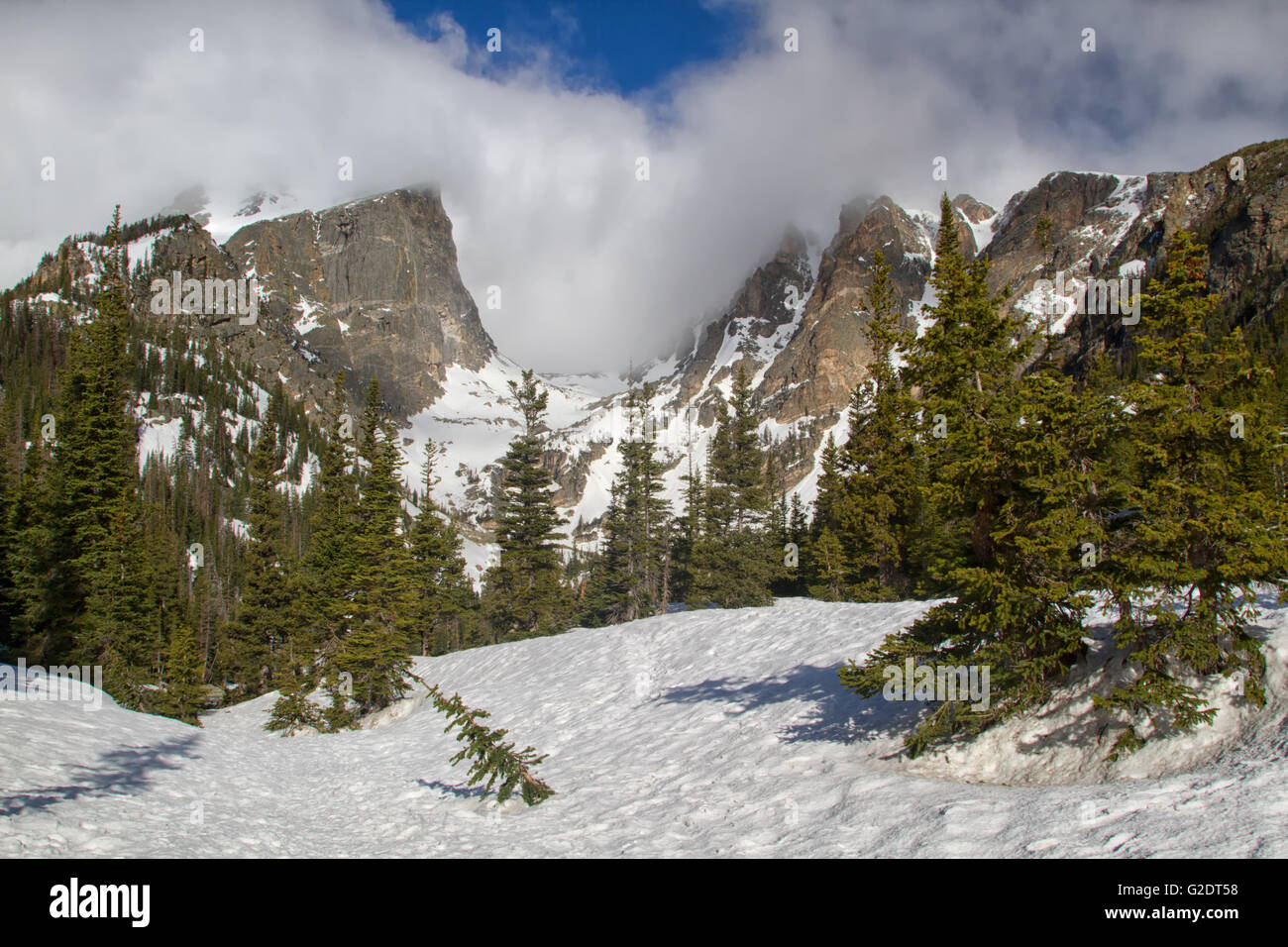 Hallett Peak and Flattop tower over the snowy landscape in Rocky Mountain National Park Stock Photo