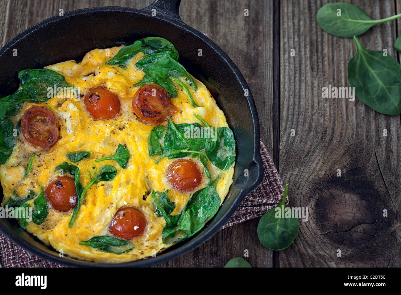 Spinach frittata in iron skillet Stock Photo