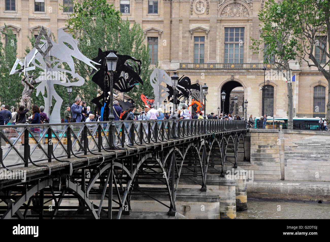 La Passerelle enchantee by Daniel Hourde Sculptor, Pont des Arts footbridge on the Seine river, Paris, France, Louvre museum Stock Photo
