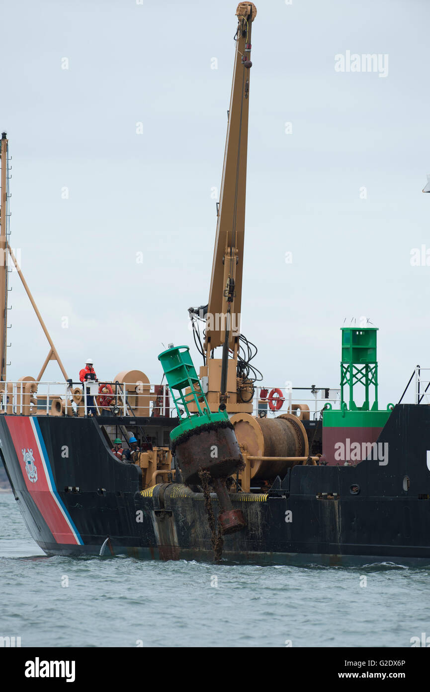 U.S. Coast Guard vessel removing shipping channel starboard marker buoy ...