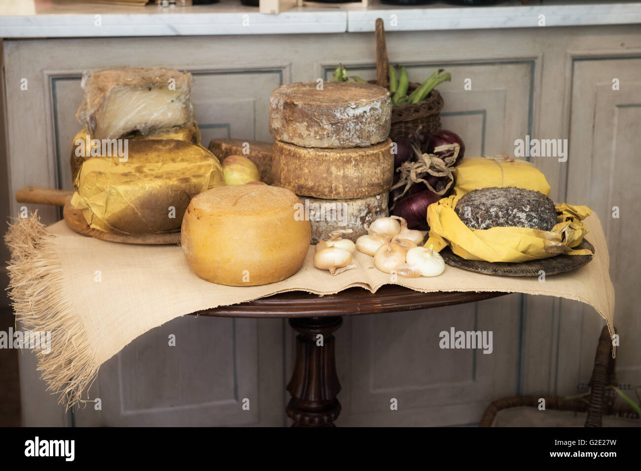 Gourmet Italian cheese wheels on a rustic display table Stock Photo