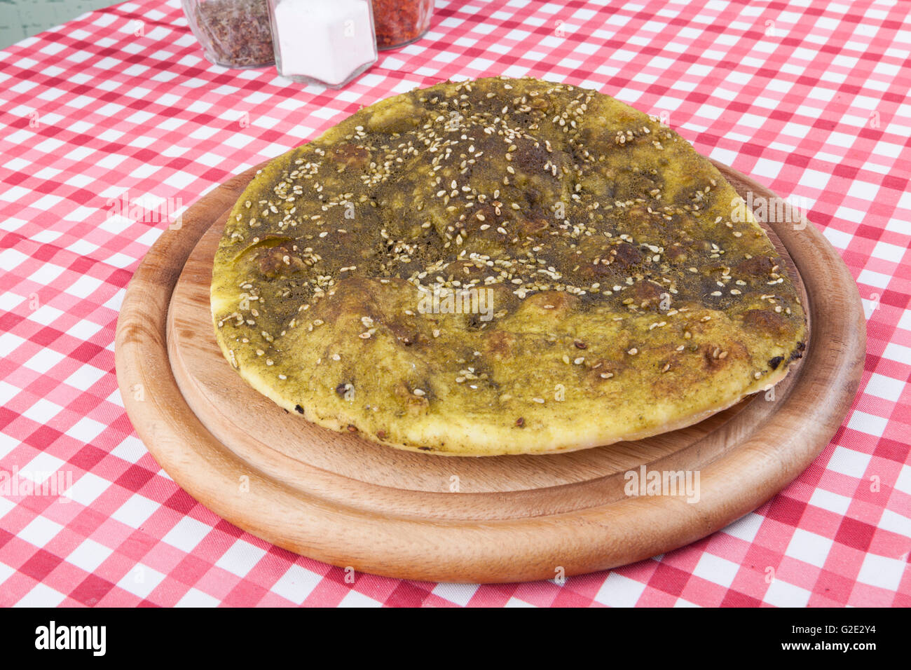 Pita bread with zaatar green middle eastern herb on wood plate Stock