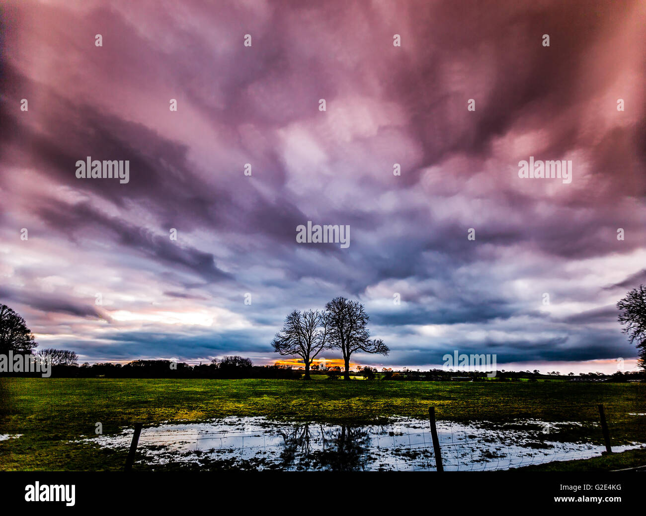 timelapse movement of storm clouds at sunset with silhouette of two ...