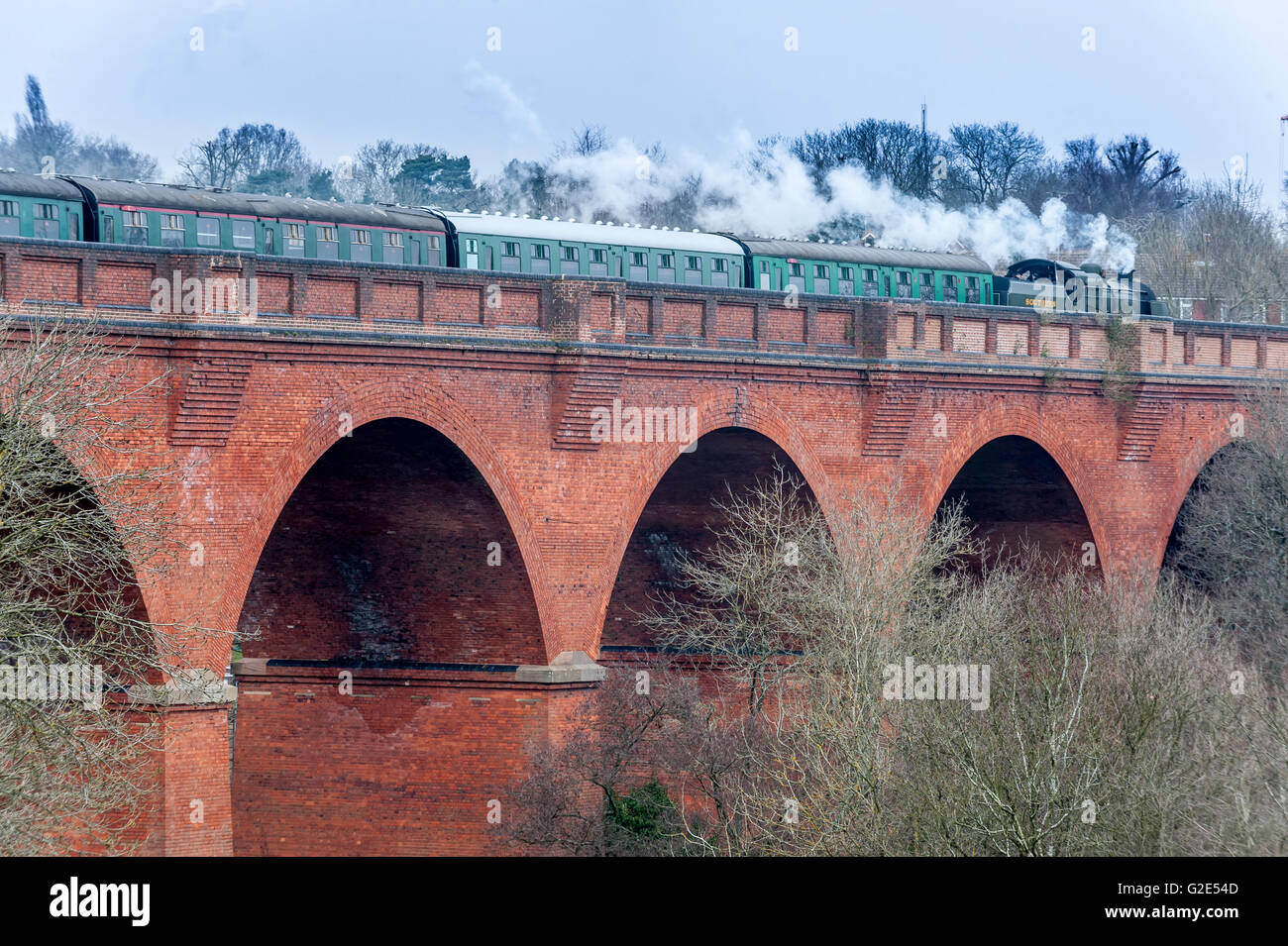 A steam train running on the Imberhorne Viaduct in East Grinstead for the first time since 1958. Stock Photo