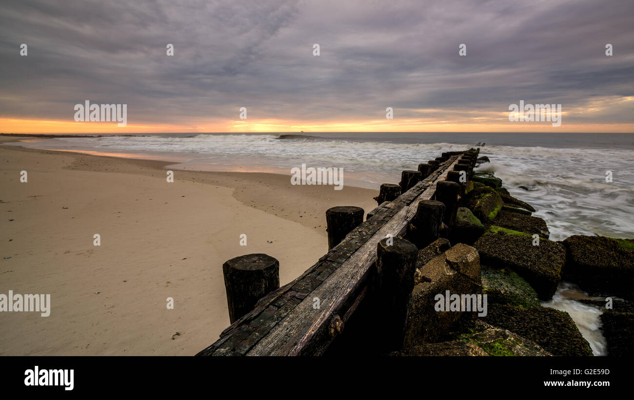 Sunrise on the Atlantic Ocean with a jetty Stock Photo - Alamy