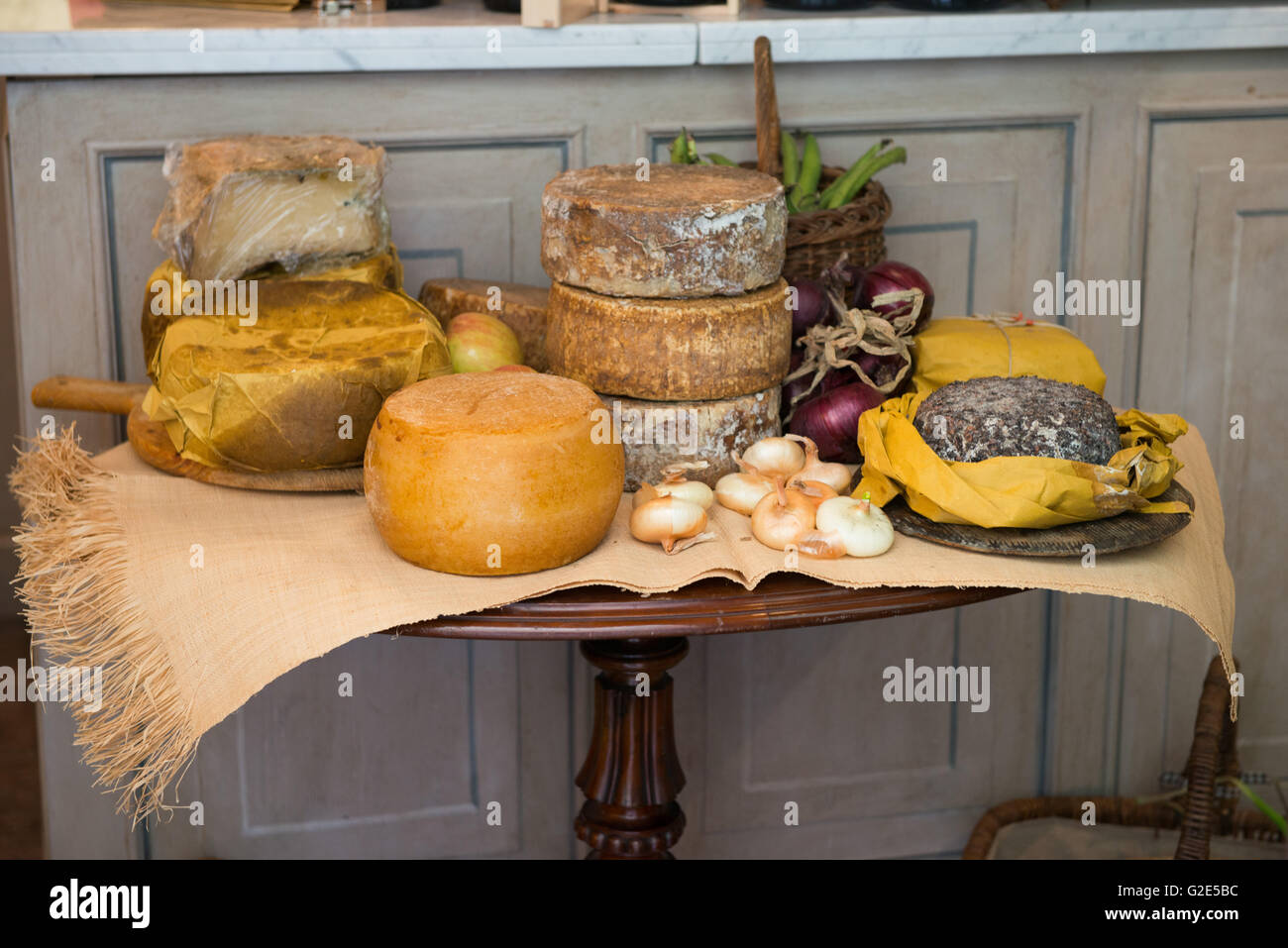 Gourmet Italian cheese wheels on a display table Stock Photo