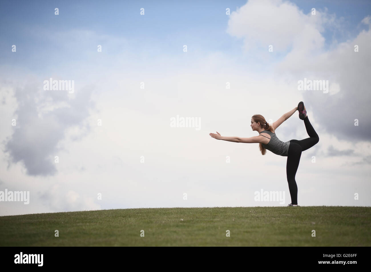 Yoga woman in park Stock Photo - Alamy