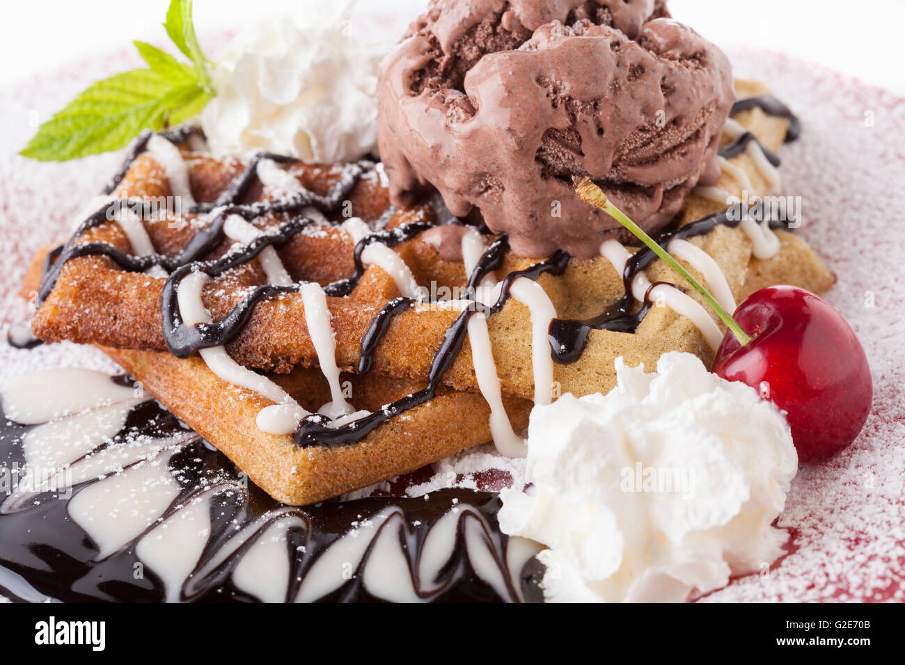 Belgian waffle with chocolate syrup whipped cream and chocolate ice ...
