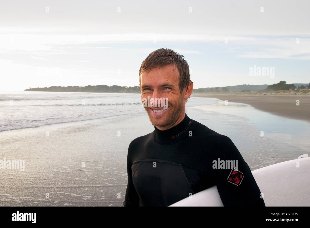 Smiling surfer on beach hi-res stock photography and images - Alamy
