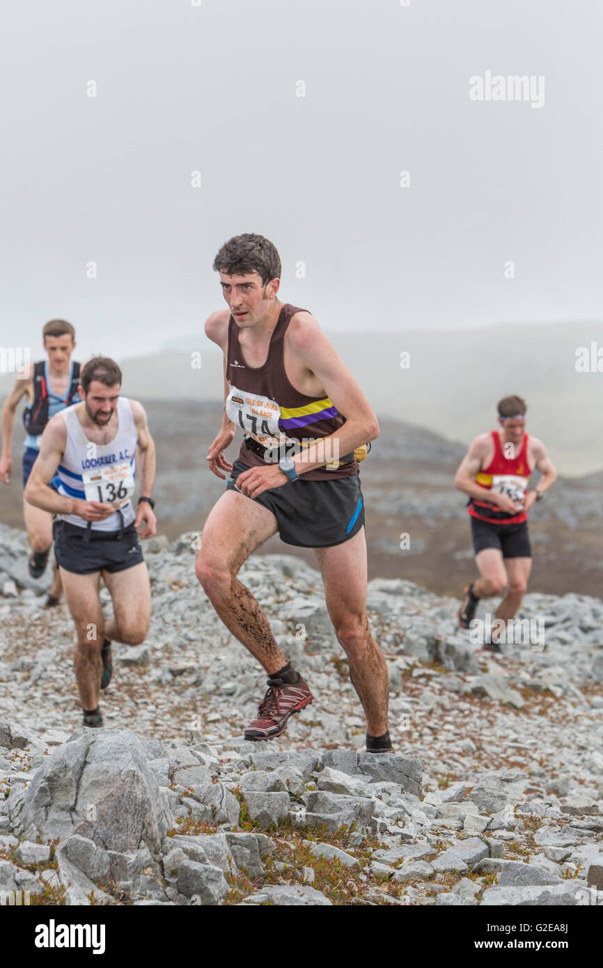 Jura, UK. 28th May, 2016. The Jura Fell Race is one of the toughest British Hill Race challenges with a 28km course taking in 7 mountain summits and a total rise of 2370m. Taking place on the Scottish island of Jura and sponsored by the Isle of Jura Distillery, over 250 runners took part in the event with the winner Finlay Wild completing the course in 3 hours 9 minutes and 53 seconds. The Women’s race was won by Jasmin Paris in 3 hours 40 minutes and 59 seconds.  Pictured: Runners entering the first checkpoint at Dubh Beinn Credit:  Richard Dyson/Alamy Live News Stock Photo