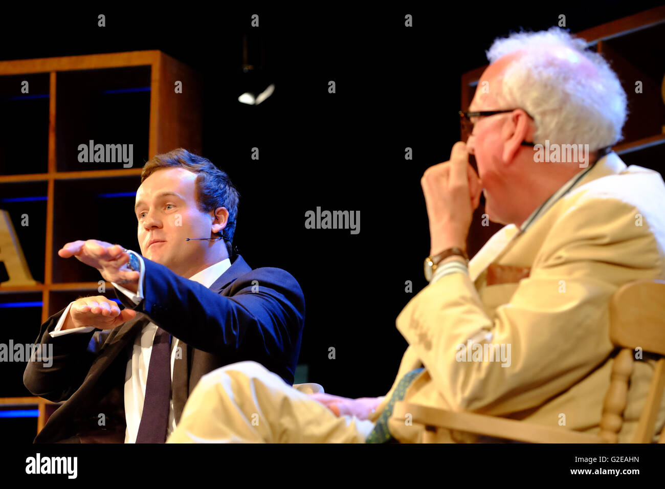 Hay Festival, Hay on Wye, Wales, UK May, 2016. Authors James Jinks ( background ) and Peter Hennessy ( foreground ) on stage talking about their new book The Silent Deep an authorative history of Britain's Submarine Service since the Second World War. Here Jinks demonstrates submarines following each other. Stock Photo