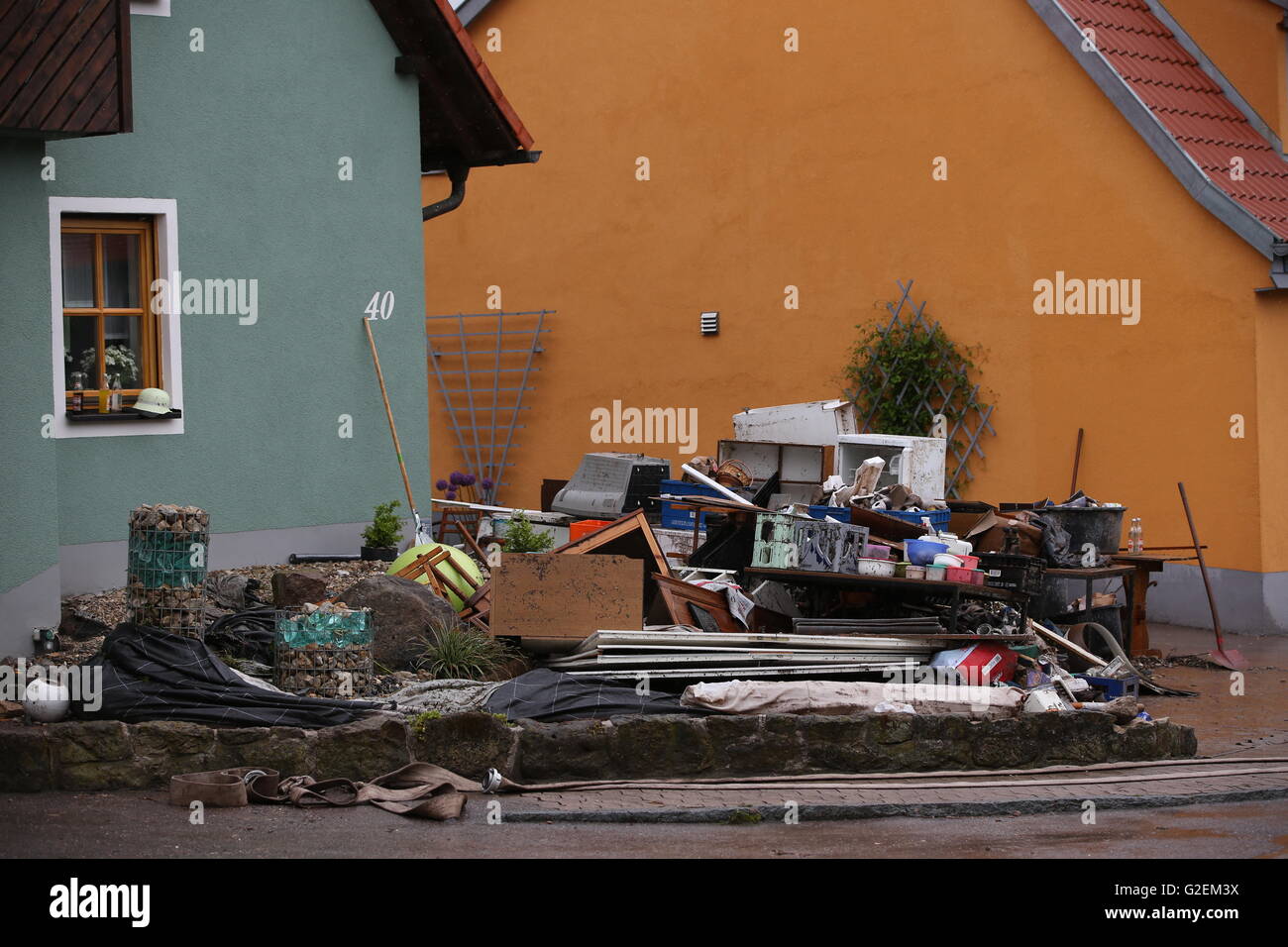 Sondernohe, Germany. 30th May, 2016. Furniture, fitments, and refuse, lie in a driveway after severe weather in Sondernohe, Germany, 30 May 2016. Overnight numerous streets and basements flooded and landslides blocked roads. Photo: DANIEL KARMANN/dpa/Alamy Live News Stock Photo