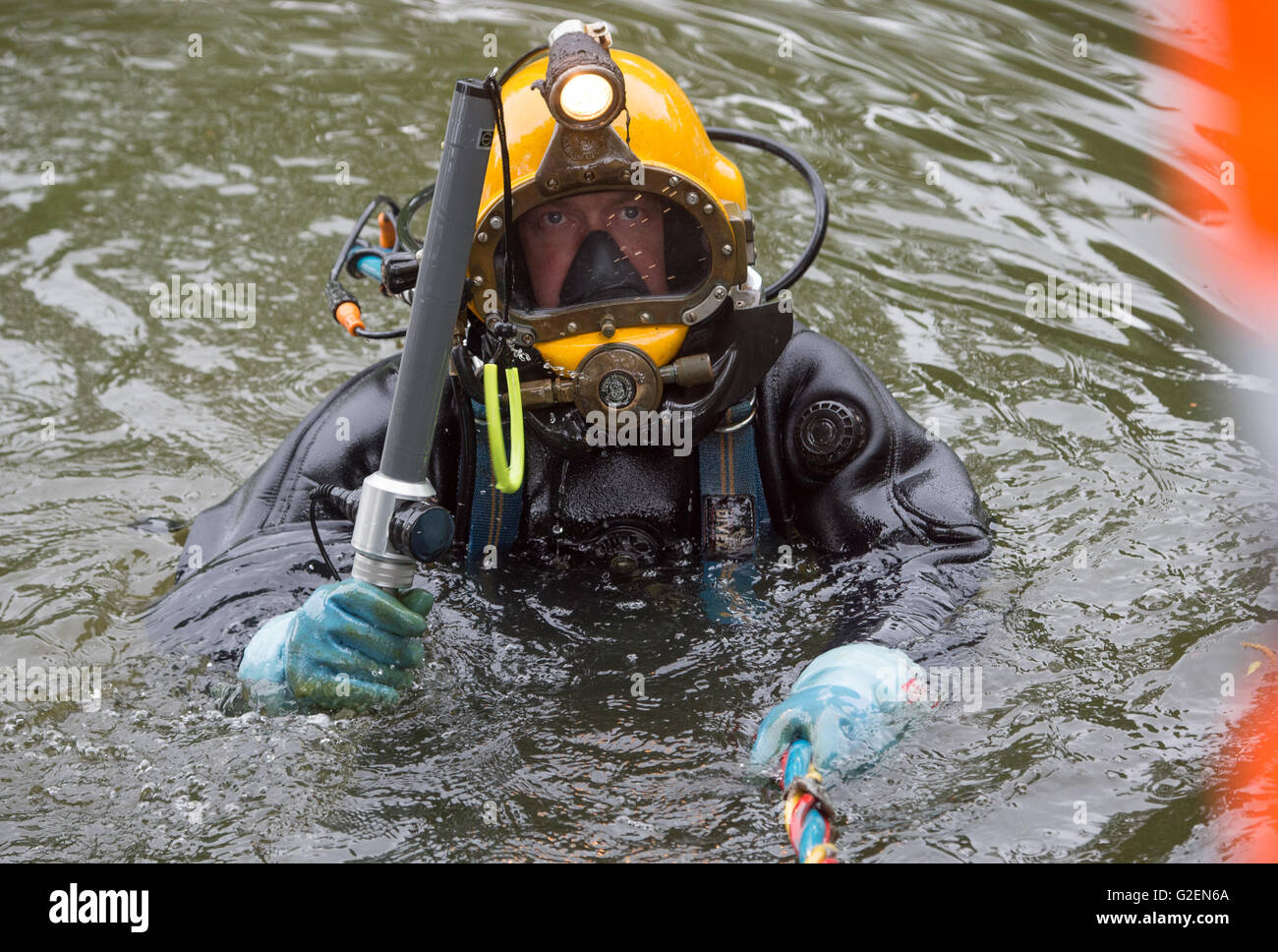 Schwalmstadt, Germany. 30th May, 2016. Munitions diver Krister Josepheit dives for munitions in the historical moat in Schwalmstadt, Germany, 30 May 2016. Retreating German troops used the moat to dispose of remaining munitions at the end of the 2nd World War. Over the next few months, these will be salvaged from the partly meter-thick slit. Photo: BORIS ROESSLER/dpa/Alamy Live News Stock Photo