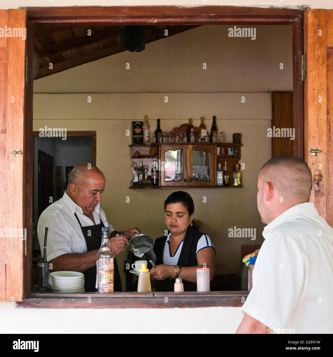 Square portrait of a local Cuban man getting served at the Coffee Museum in Topes de Collantes, Cuba. Stock Photo