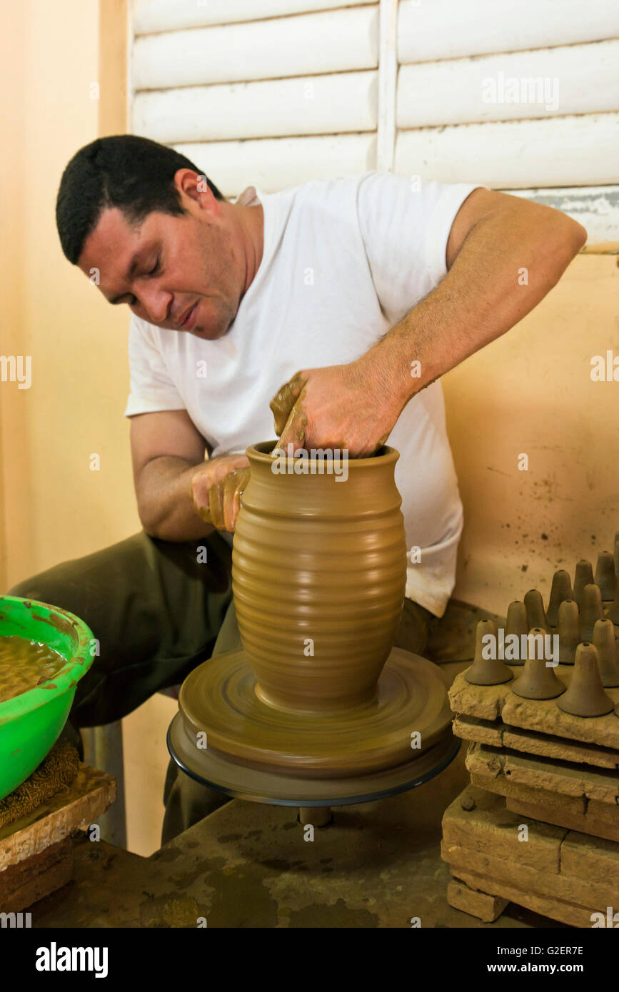 Vertical portrait of a potter sitting at the wheel in Trinidad, Cuba. Stock Photo