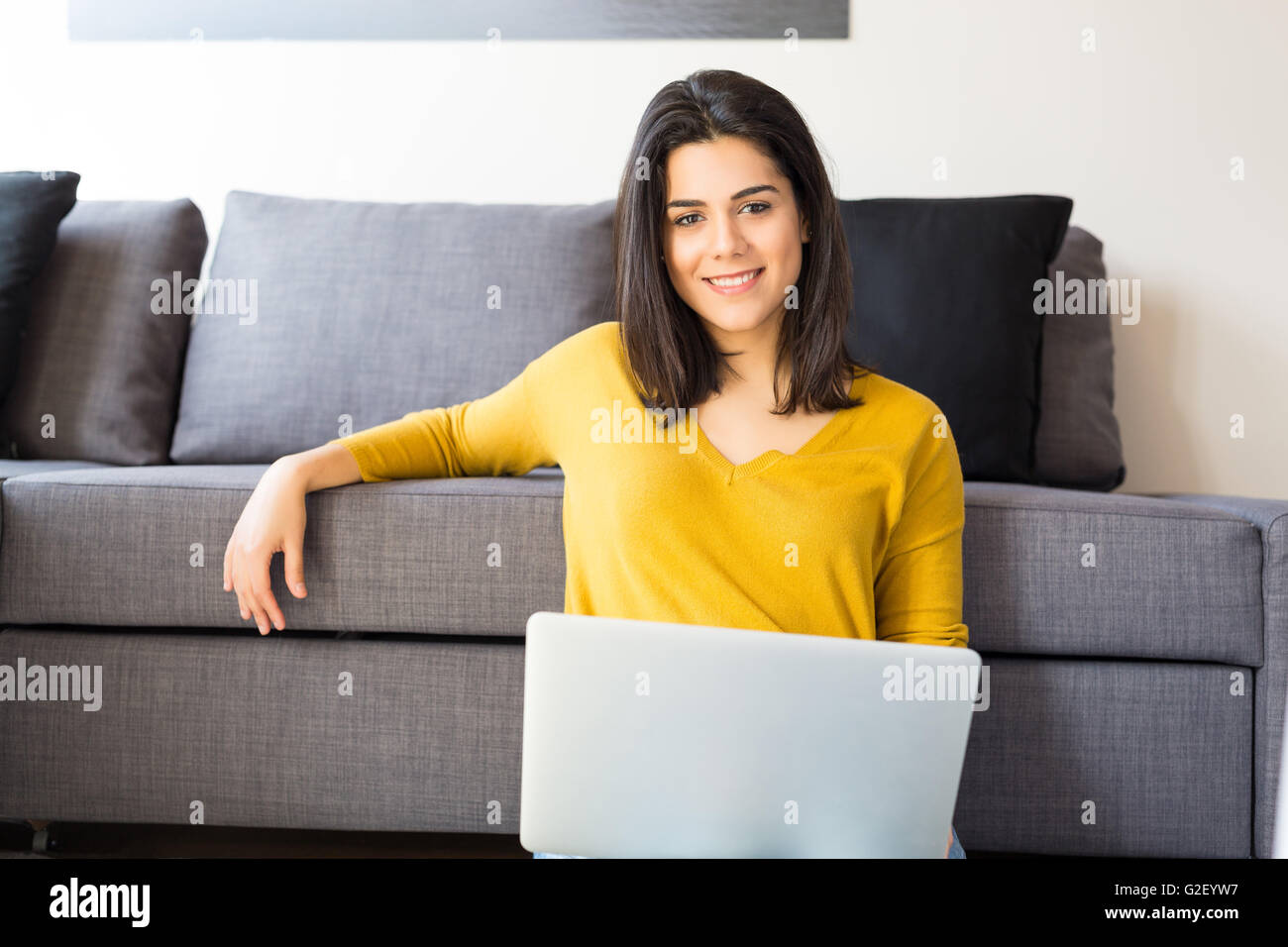 Beautiful woman relaxing with a computer Stock Photo - Alamy