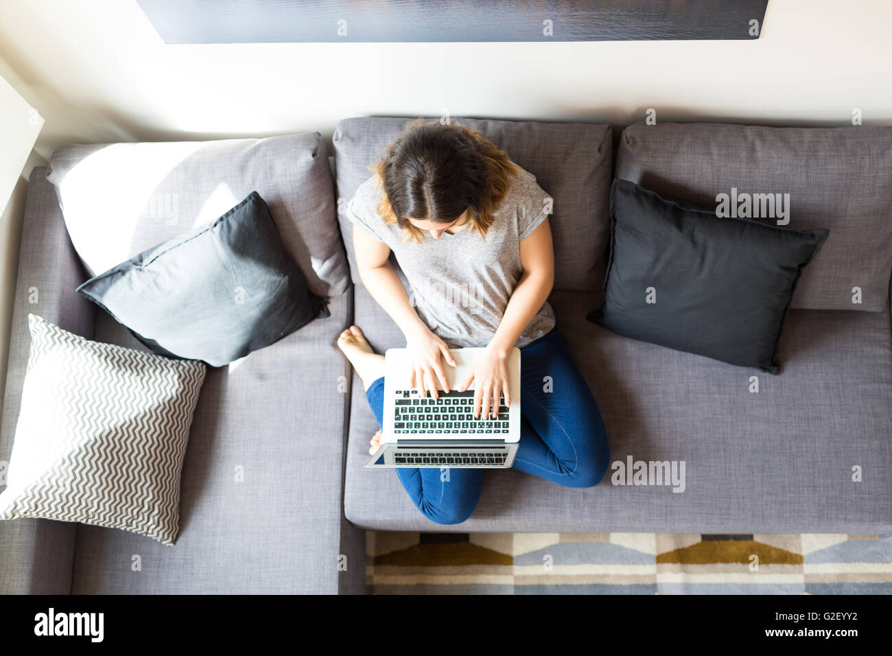 Beautiful woman relaxing with a computer Stock Photo - Alamy
