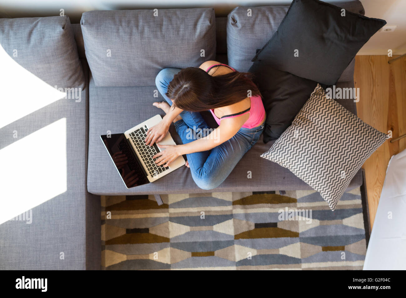 Beautiful woman relaxing with a computer Stock Photo - Alamy