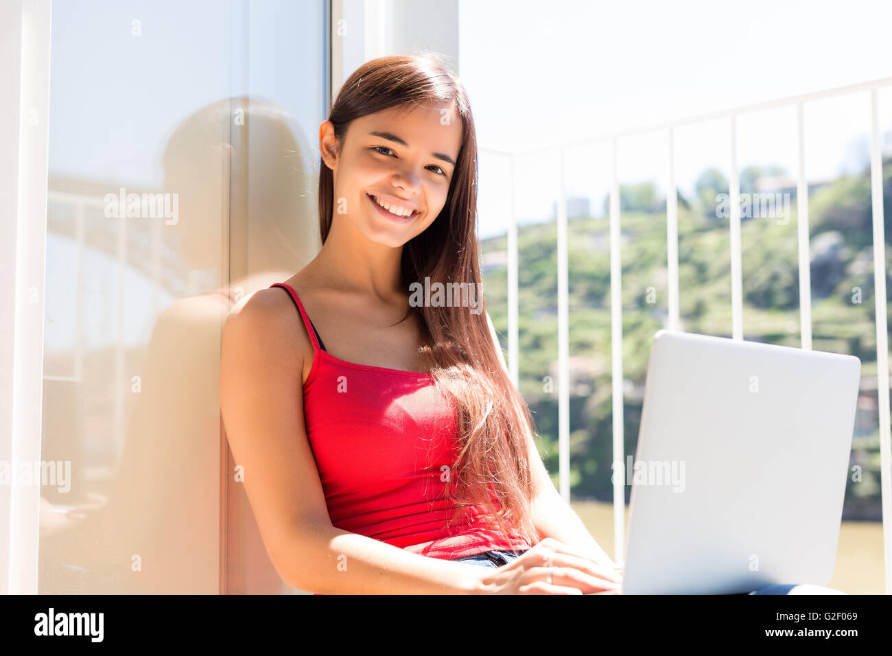 Beautiful woman relaxing with a computer Stock Photo - Alamy
