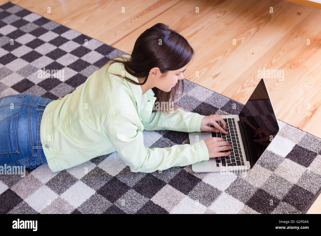 Beautiful woman relaxing with a computer Stock Photo - Alamy