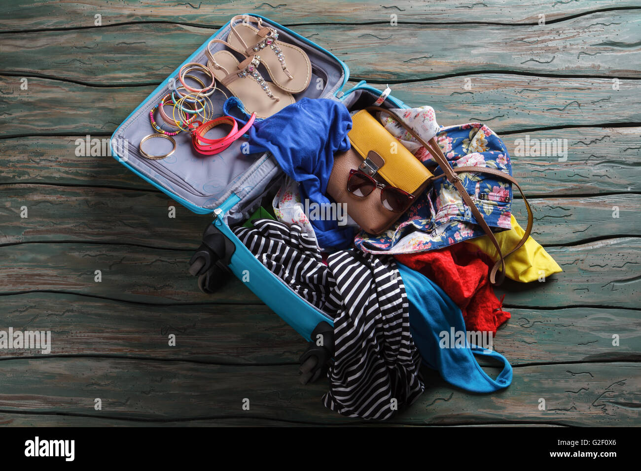 Opened suitcase with crumpled clothes. Stock Photo