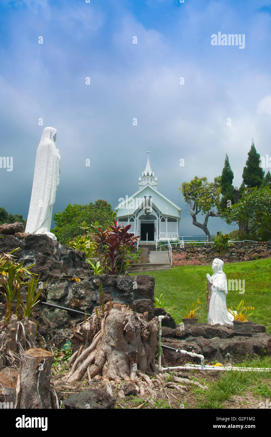 Painted church and two praying statues on Big Island Hawaii Stock Photo ...