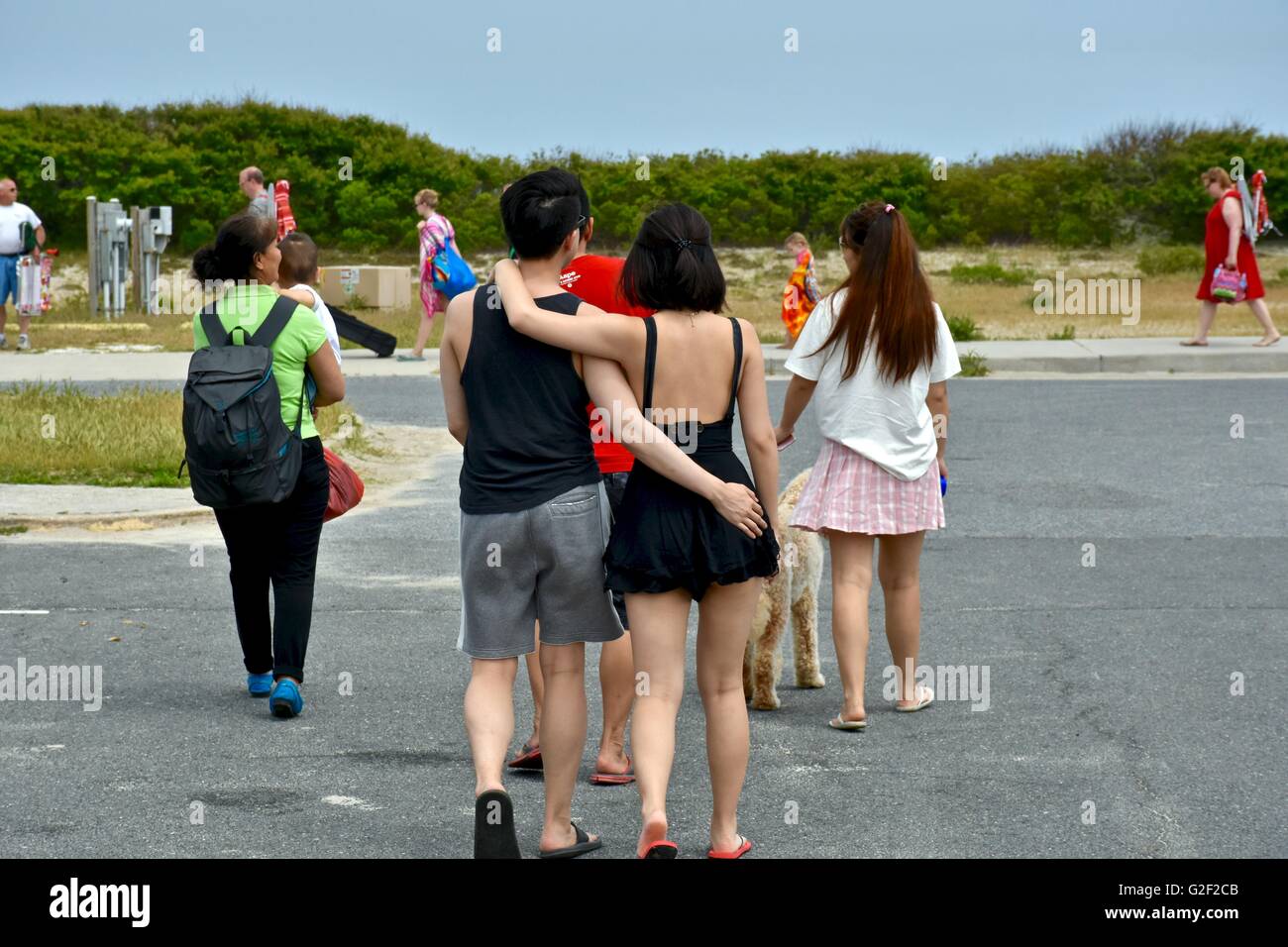 A couple with arms wrapped around each other walking to the beach Stock ...