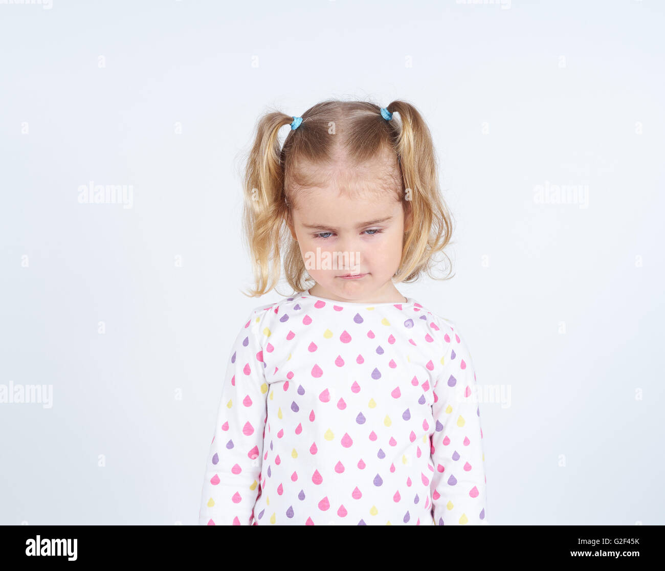 Little girl looking down hurt. Emotions. Stock Photo