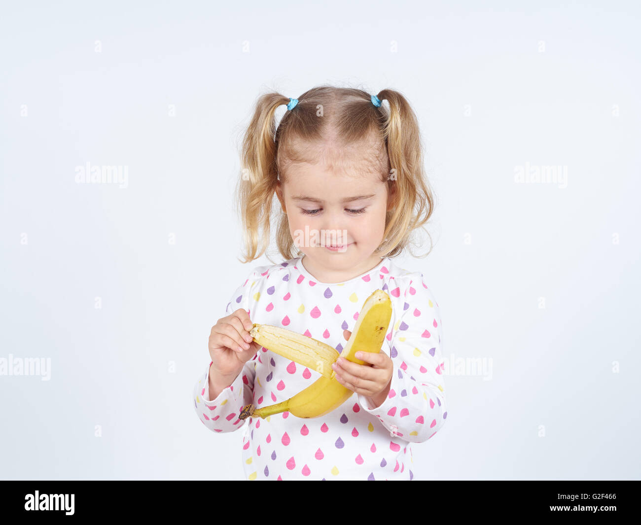 Little girl eating banana hires stock photography and images Alamy