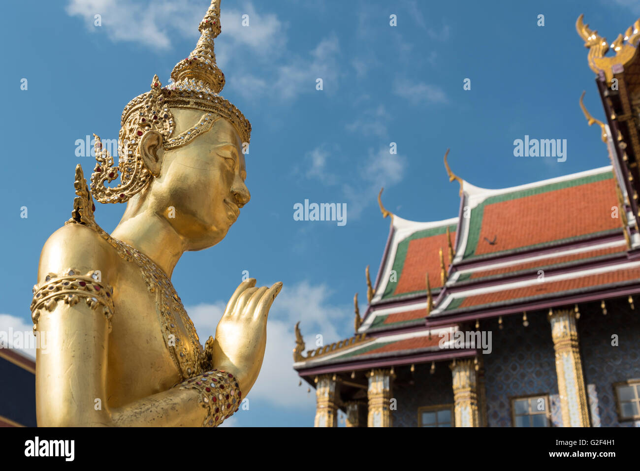 Golden statue of mythical deity Kinnorn (Kinnara) in front of Royal Pantheon at Wat Phra Kaew Temple, Grand Palace, Bangkok, Tha Stock Photo