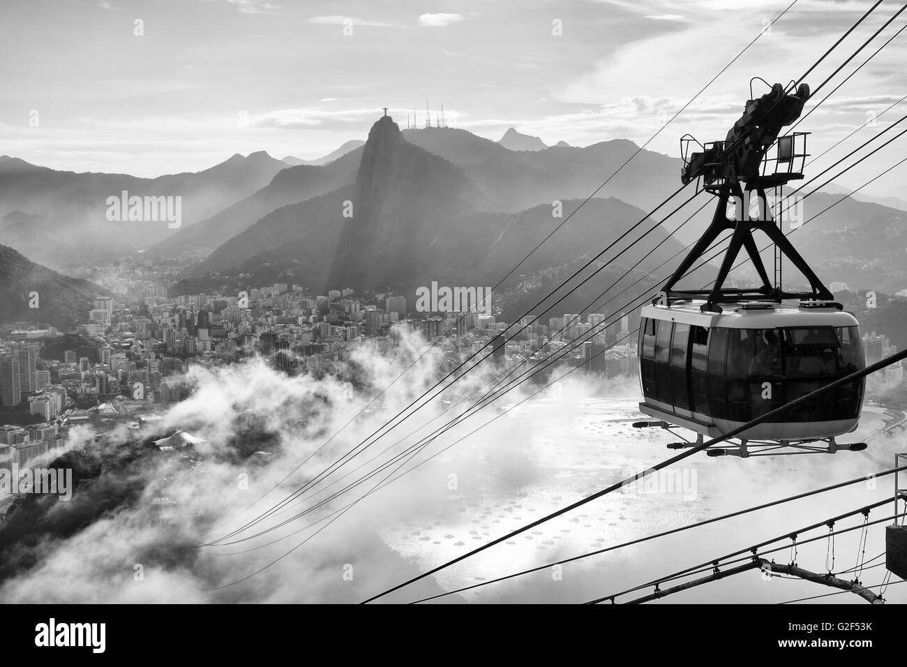 Black and white view of the misty city skyline of Rio de Janeiro, Brazil with a Sugarloaf (Pao de Acucar) Mountain cable car Stock Photo