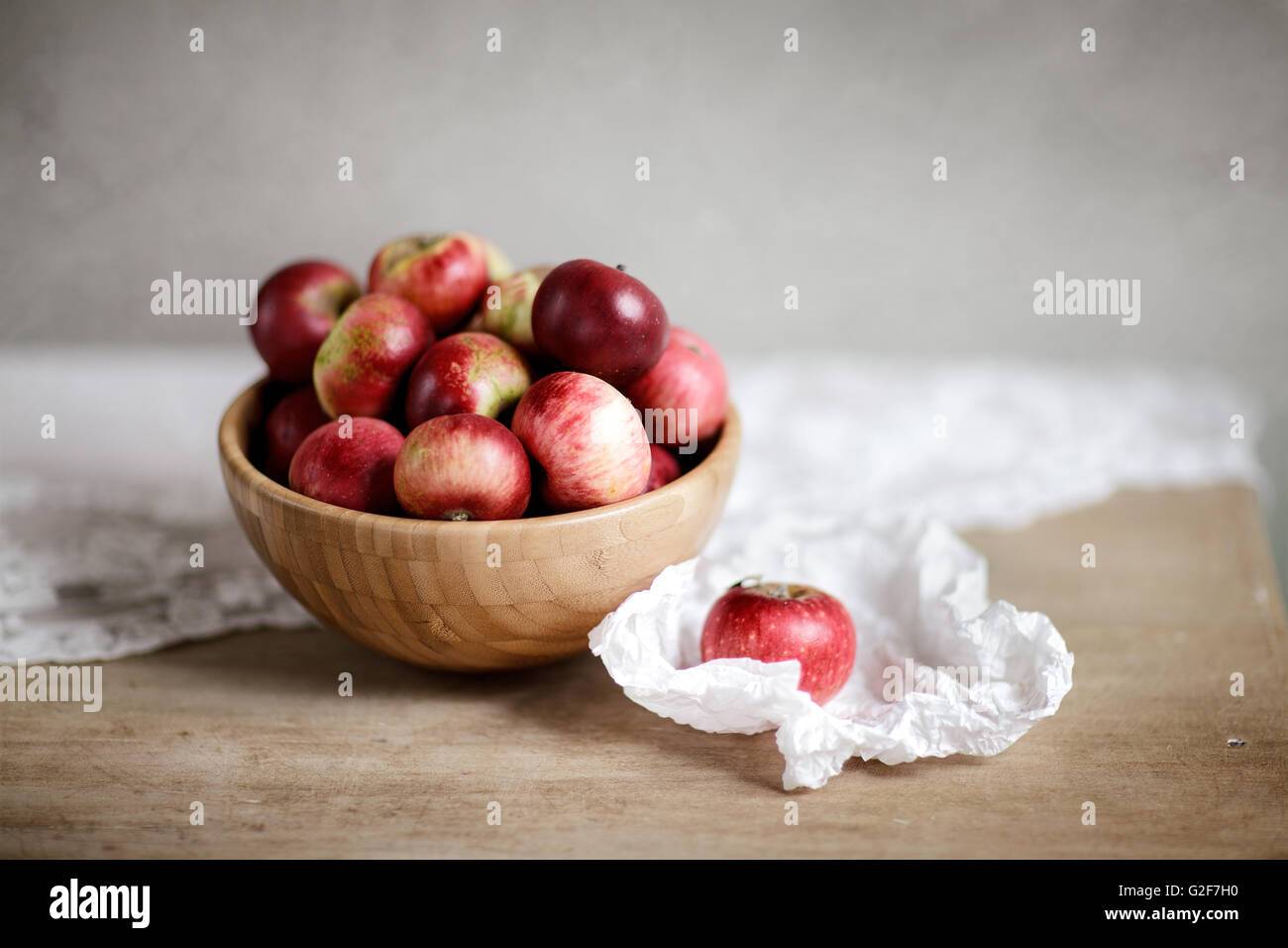 Ripe red Apples arranged on table in wooden bowl Stock Photo - Alamy